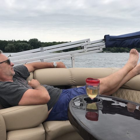man-relaxing-on-boat-with-drink-in-summer-2026-01-05-01-14-26-utc